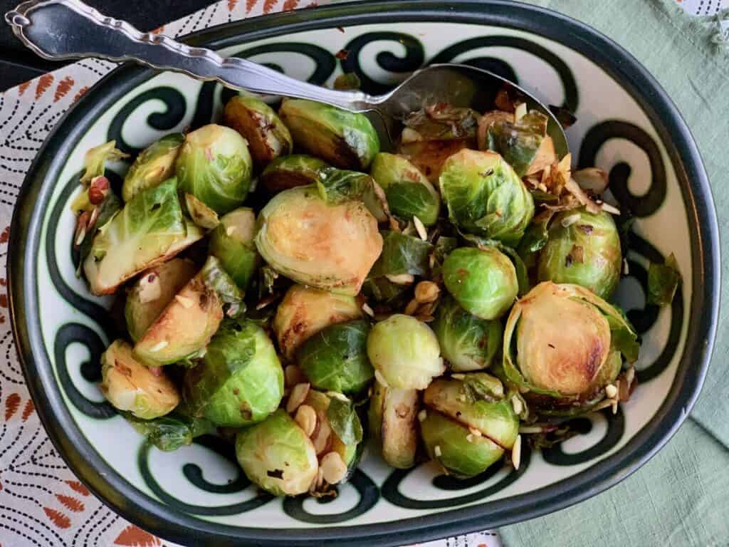 Brussels Sprouts with Almonds served in a pottery bowl.