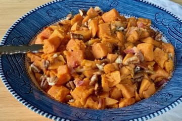 Sweet Potatoes with Bacon and Pecans served in a Courier and Ives Ironstone serving bowl.
