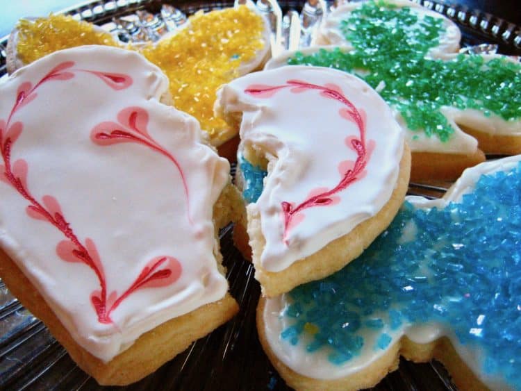 Sugar Cookies, one decorated as a broken heart with Royal Icing and butterfly cookies with decorator sugar.