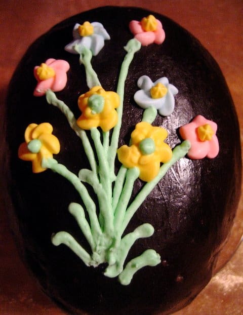 Peanut Butter Fudge Egg covered with Chocolate Fondant and decorated with icing flowers