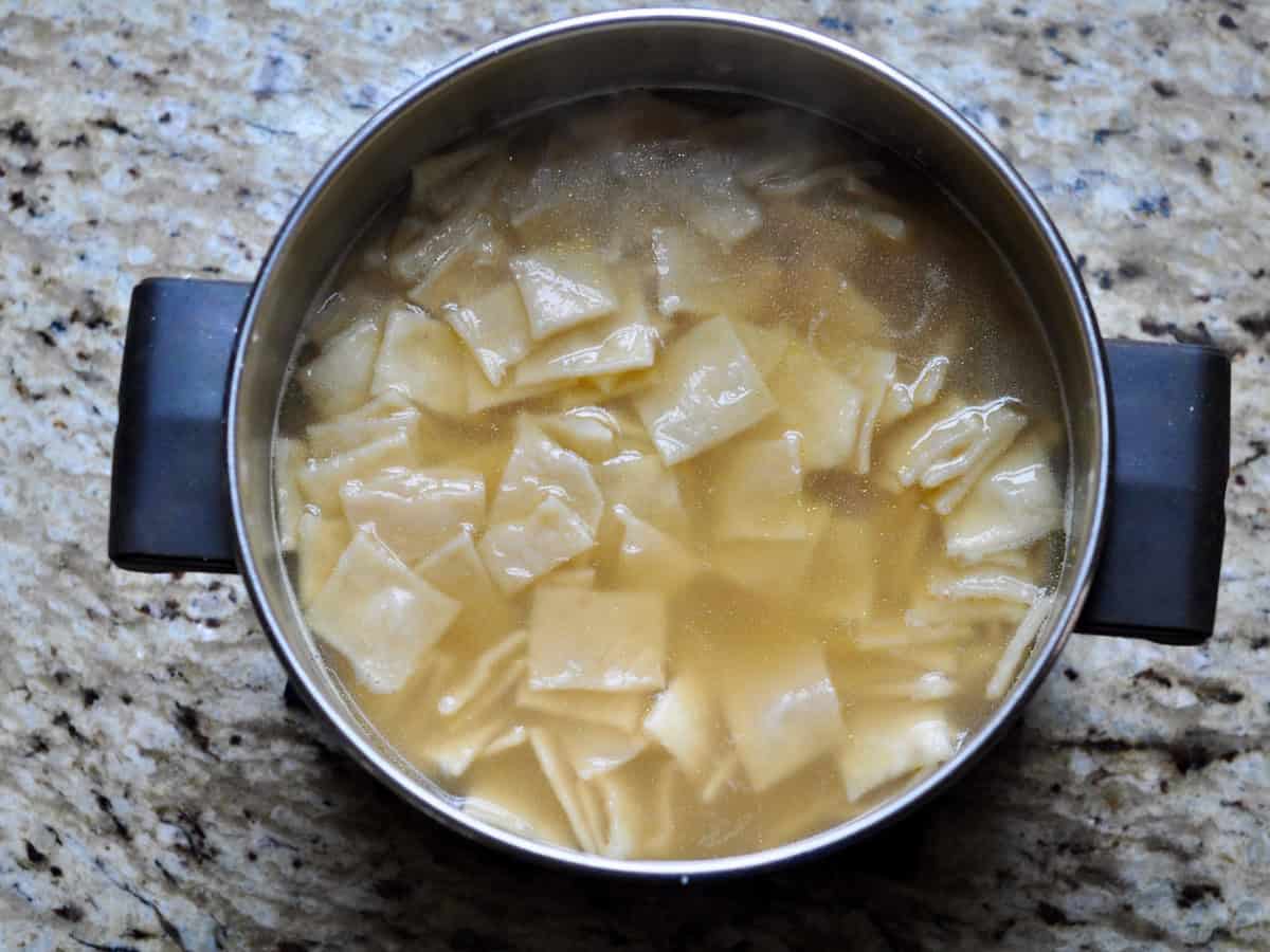 Dumplings cooked in a pot of chicken broth for Chicken and Dumplings.