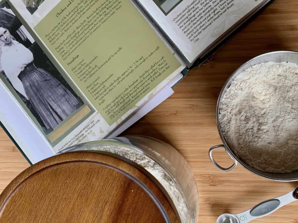 Measuring ingredients for dumplings while using a recipe in my Family Heirloom Cookbook.