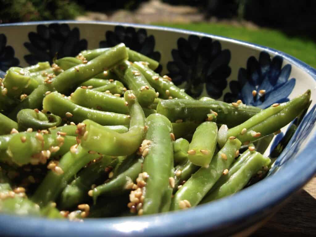 Green Beans with Sesame-Ginger Dressing in a stoneware bowl.