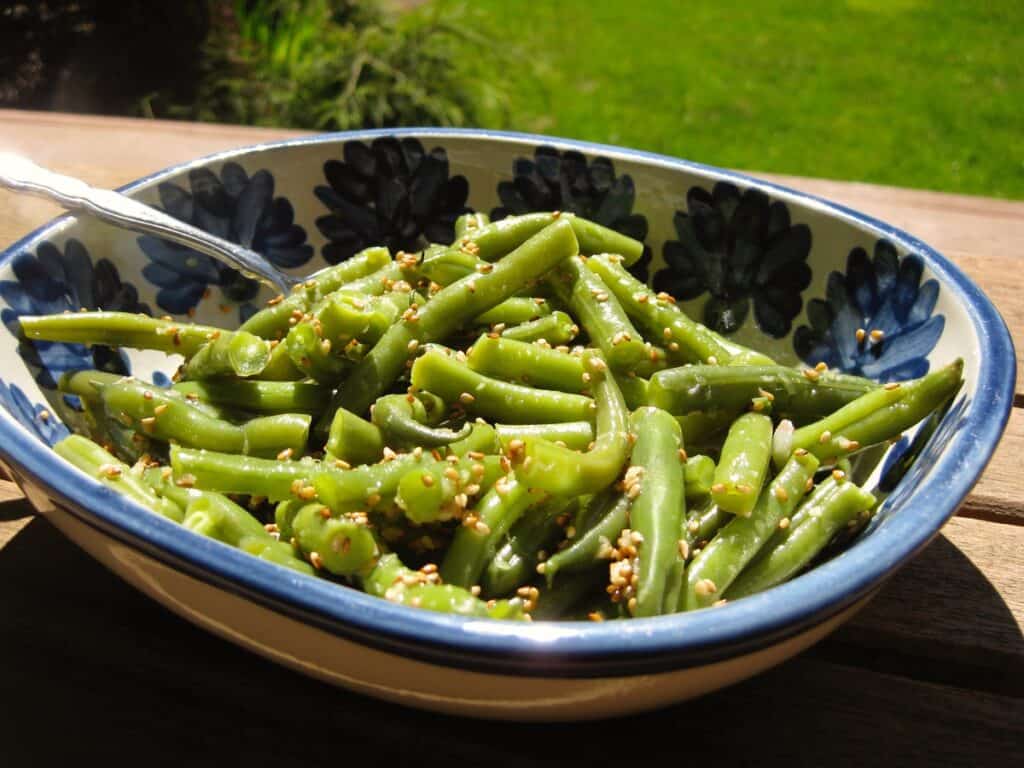 Green Beans with Sesame-Ginger Dressing in a stoneware bowl.