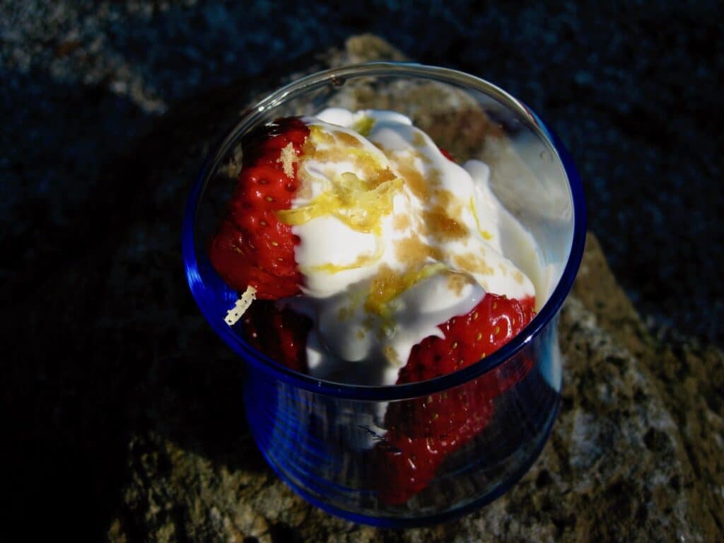 Strawberries in Golden Sake Sauce garnished with Lemon Zest and Brown Sugar.