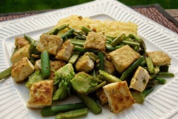 Chopped and sautéed Garlic Spears with Tofu is served with Basic Italian Polenta.