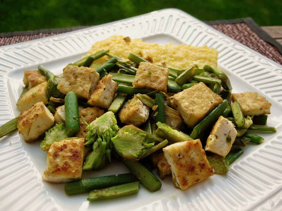 Chopped and sautéed Garlic Spears with Tofu is served with Basic Italian Polenta.