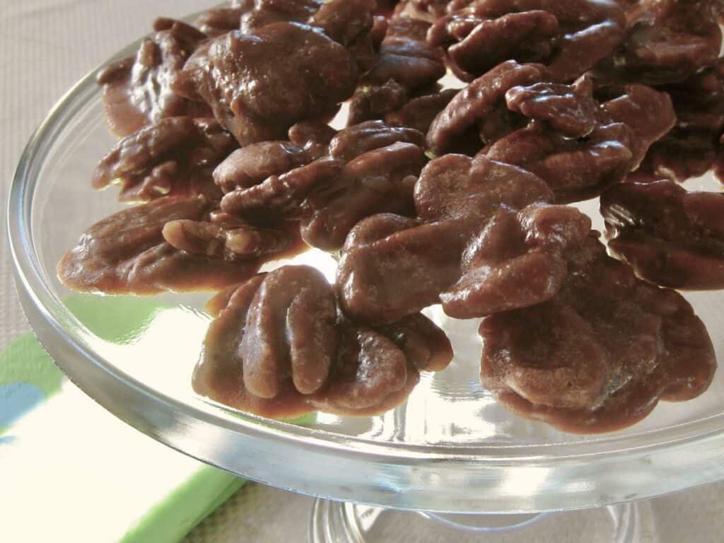 Microwave Pralines are arranged on a clear glass cake plate.