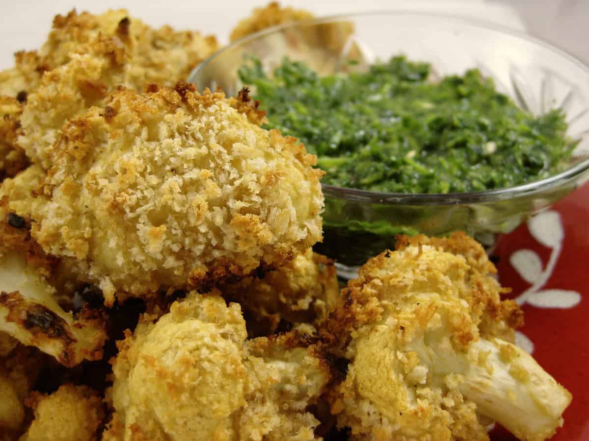 Baked Cauliflower Pakoras are coated with crispy panko crumbs and served with Cilantro Mint Dipping Sauce.