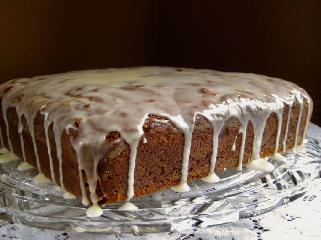 Old-Fashioned Gingerbread cake with a glaze dripping down the sides.