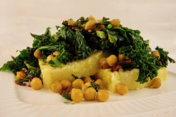 Kale with Sun-dried Tomatoes and Garbanzo Beans is served over thick slices of Italian Polenta.