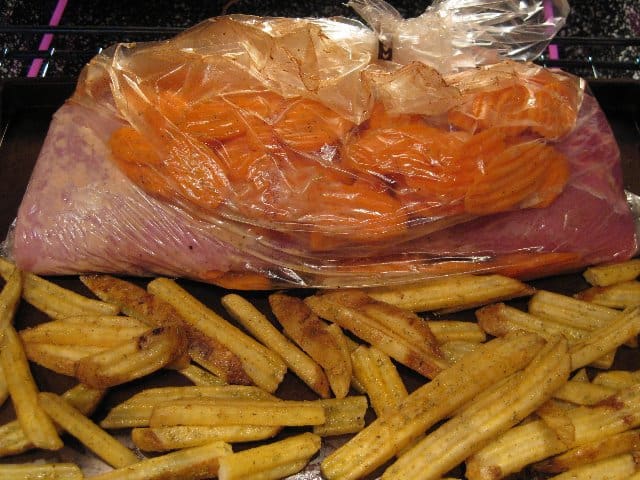 Maple Glazed Pork Tenderloin cooks with carrots in an oven cooking bag.