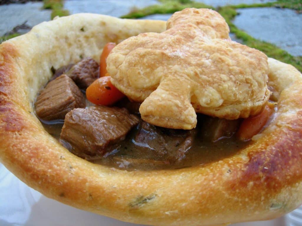 A garden view of A Good Irish Stew served in a Bread Bowl and topped with a puff pastry Shamrock.
