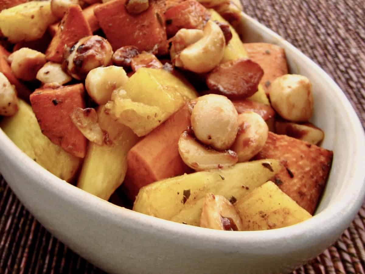 Roasted Sweet Potatoes and Pineapple with Macadamia Nuts in an oval bowl.