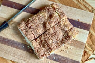 Slices of Cinnamon Coffee Cake on a wood cutting board.