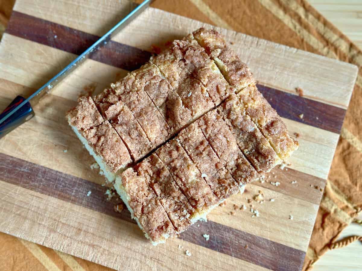 Slices of Cinnamon Coffee Cake on a wood cutting board.