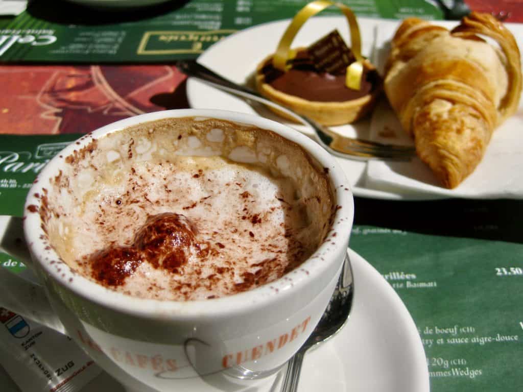 A cappuccino, a croissant and a chocolate tart at Place St. Francois in Lausanne, Switzerland.