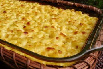Macaroni and Cheese baked in a 9 x 13-inch casserole dish nestled in a basket.