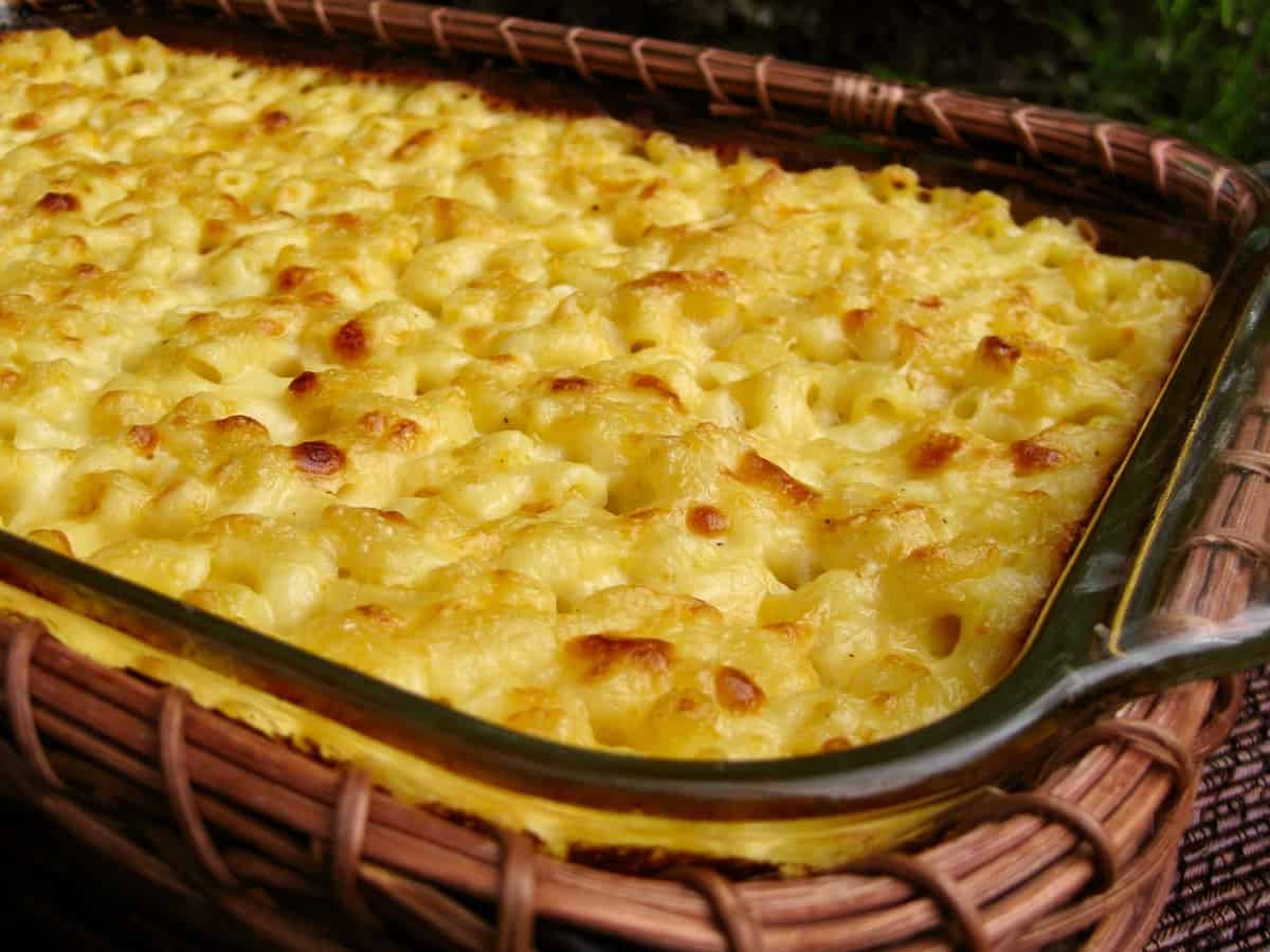 Macaroni and Cheese baked in a 9 x 13-inch casserole dish nestled in a basket.