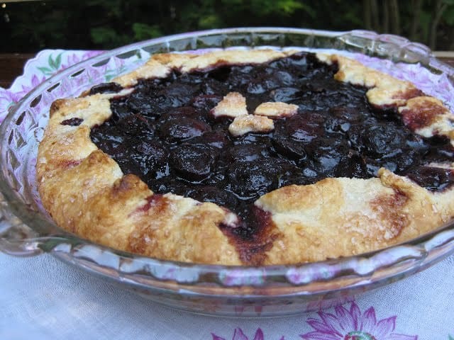 Whole Hot Cherry Crostata in Pie Plate on antique cloth