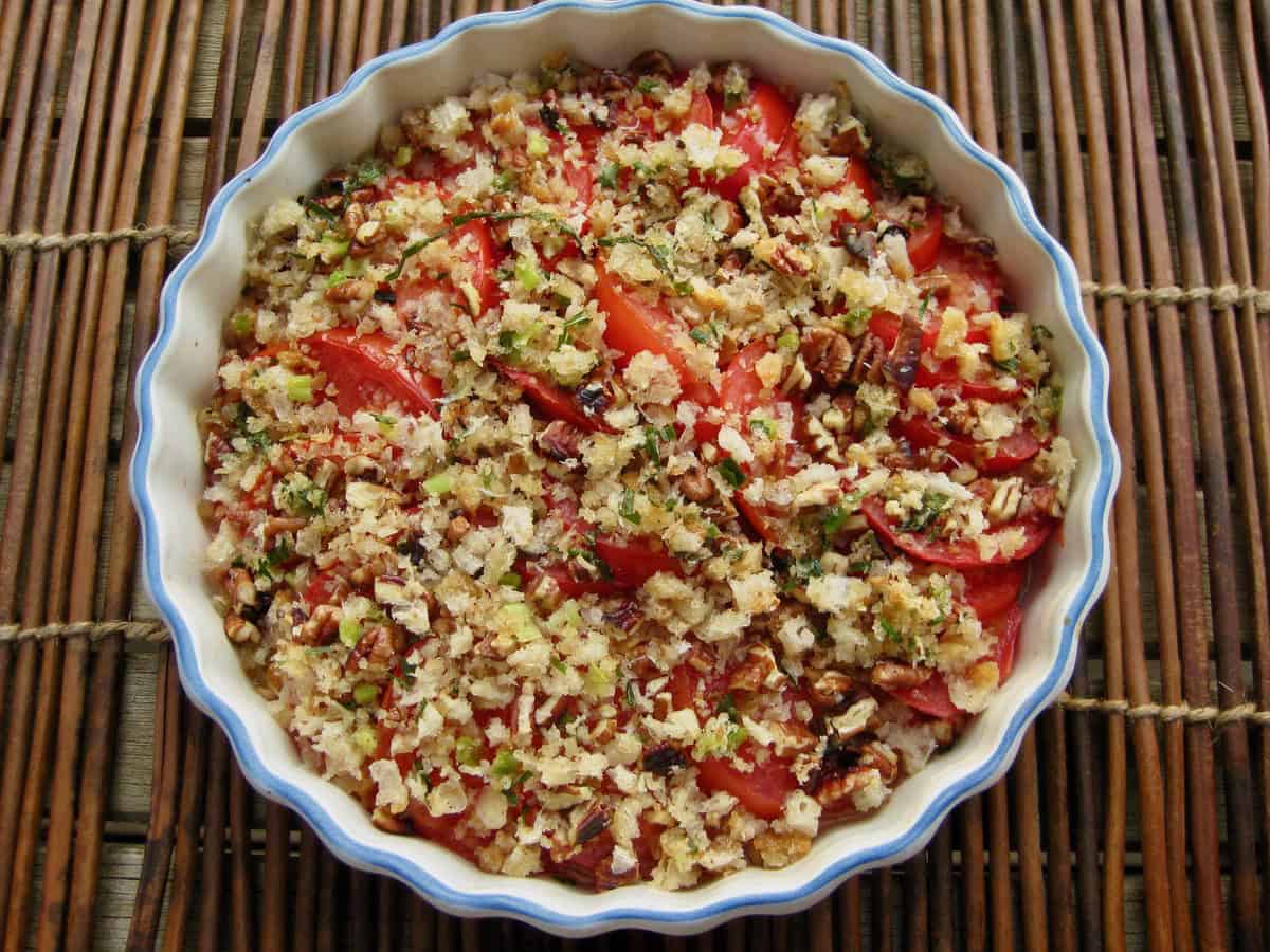 Fresh Tomato Scallop served in a low dish on a rustic mat.