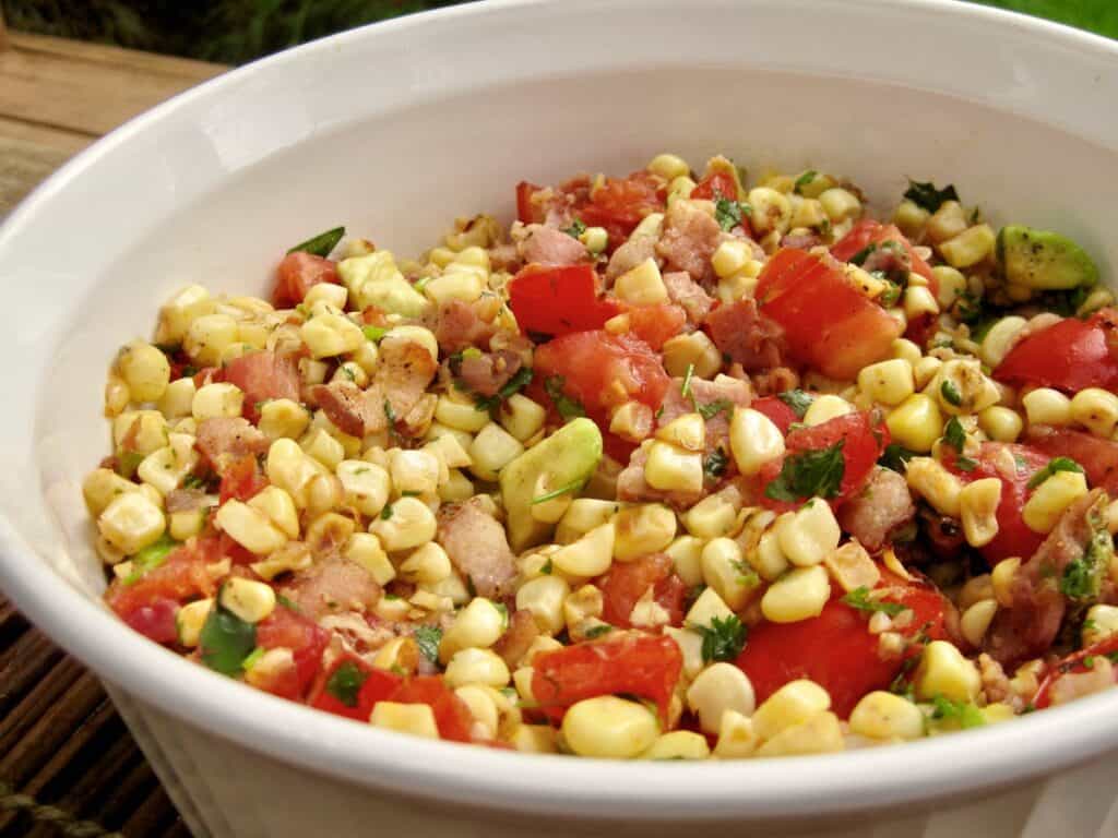 Pan Roasted Corn with Tomato Salad served in a white bowl.