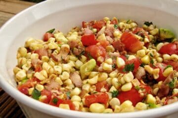 Pan Roasted Corn with Tomato Salad served in a white bowl.