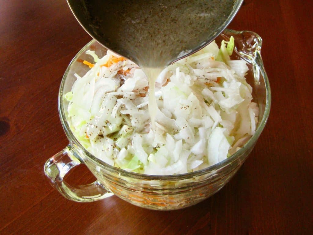 An oil and vinegar based dressing flavored with dry mustard and celery seed in boiled and then poured over Railroad Cole Slaw.