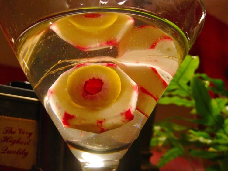 Radish Eyeballs in clear beverage served in a martini glass.