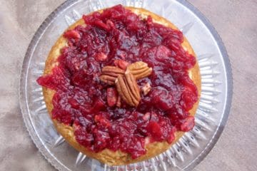 Cranberry Cheesecake Spread with Cranberry Sauce on top and a garnish of pecans, viewed from above.