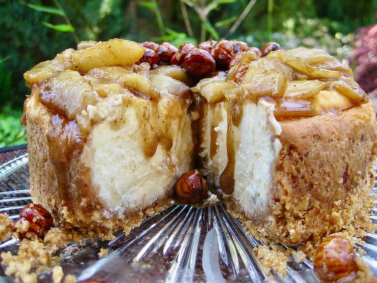 Looking into a Smoky Blue Cheesecake with Hazelnut Pear Topping that has one slice taken.