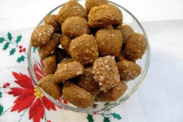 A small glass bowl filled with Peppernuts (Pfeffernuesse), a spicy bite-sized cookie.