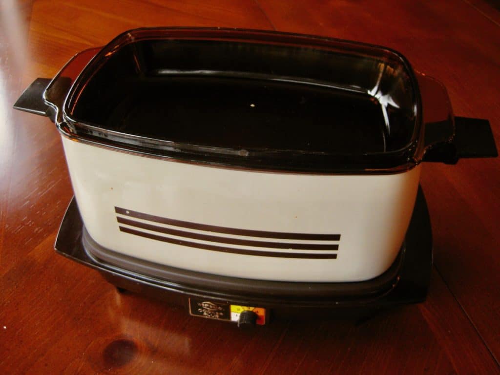 A vintage Westbend Cooker Plus assembled to use as a chafing dish.