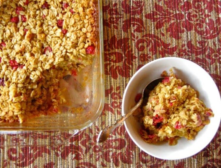 Cranberry Orange Baked Oatmeal scooped from a serving dish into an individual bowl.