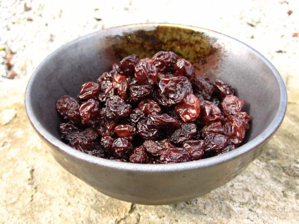 Eating your words, would they taste as sweet as the raisins piled in this rustic bowl?
