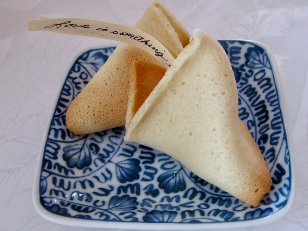 A Homemade Fortune Cookie broken to reveal a handwritten fortune.