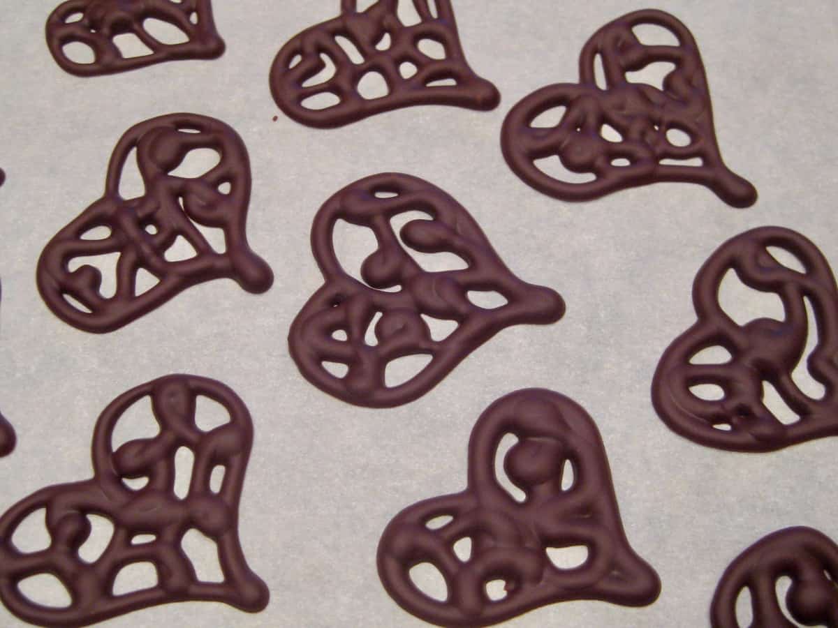 Melted chocolate is piped into Filigree Chocolate Hearts