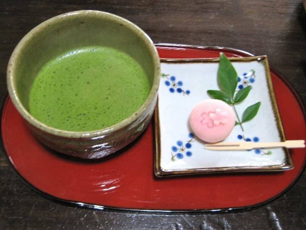 Matcha Tea served beside a cherry blossom tea sweet at a teahouse on Mt. Shosha, Japan.