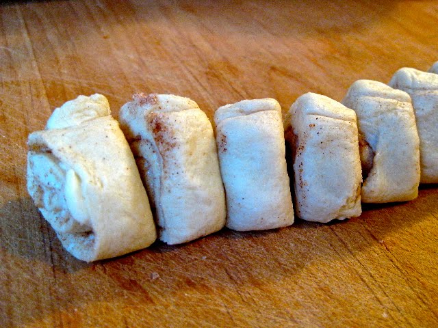 Cinnamon Roll Dough cut and ready to place in a baking dish.