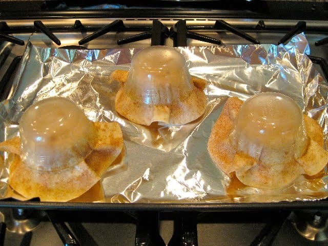 Tortilla Cups baking in the oven with custard cups on top to make the shape