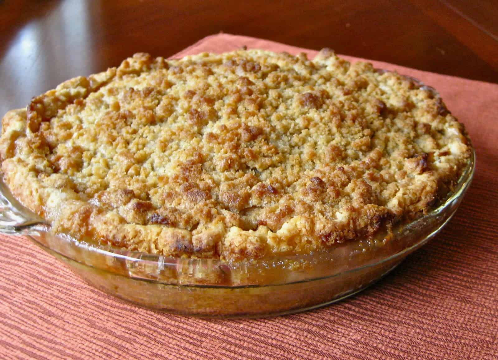 A French Apple Pie topped with a golden layer of crisp cinnamon streusel.