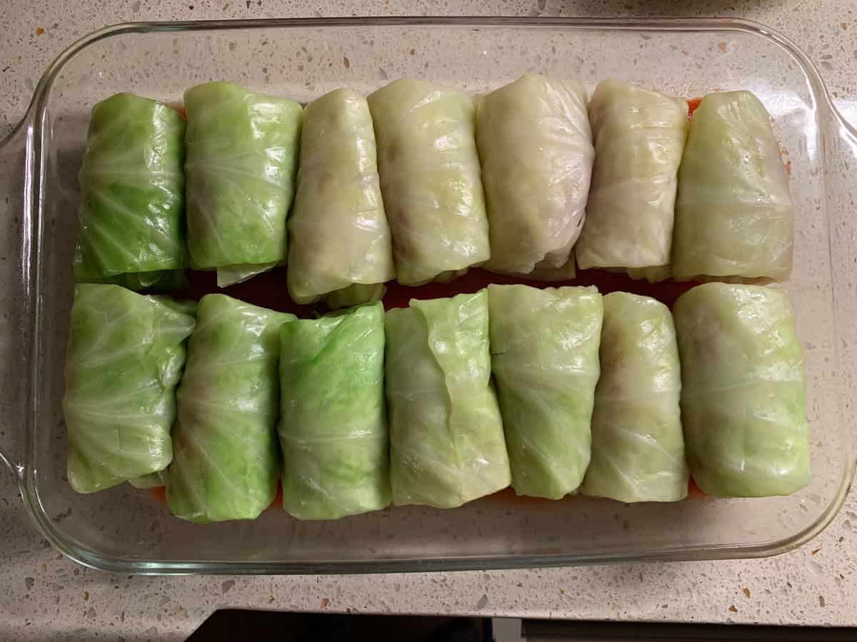 Cabbage rolls arranged in a pan before adding the sauce to make Galumpki.