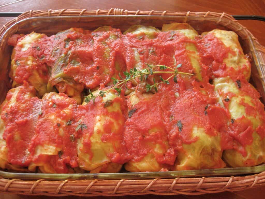 Stuffed Cabbage Rolls, filled with a mixture of meat and rice and covered in a tomato sauce, for Halupsi, or Gram's Galumpki.