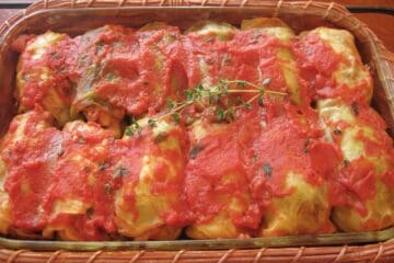 Stuffed Cabbage Rolls, filled with a mixture of meat and rice and covered in a tomato sauce, for Halupsi, or Gram's Galumpki.