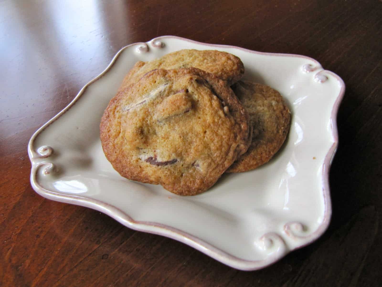 A few Chocolate Chip Cookies on a square plate.