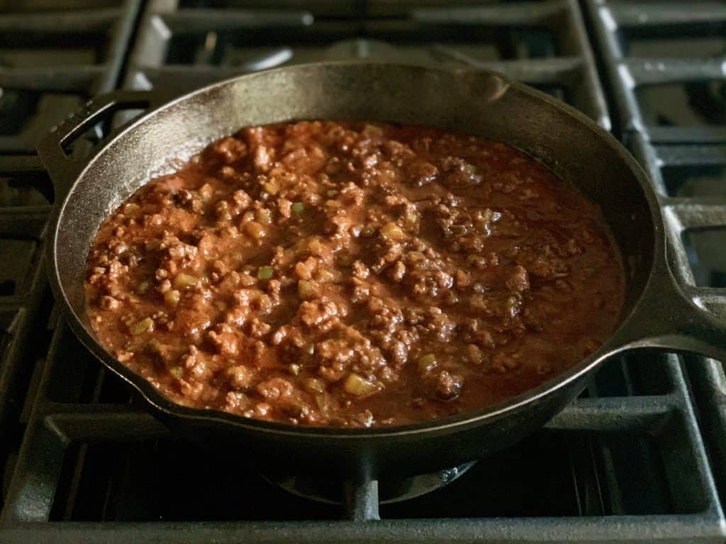 Mama Jean's Barbecue in a cast iron skillet simmering on the stovetop.