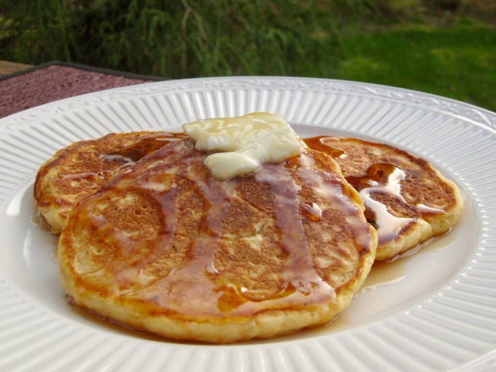 Sweet Potato Pancakes topped with butter and syrup.