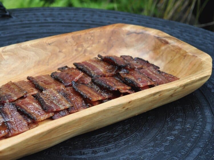 Candied Bourbon Bacon Bites served on a wood tray.