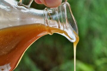 Caramel Sauce is pouring from a small antique pitcher.