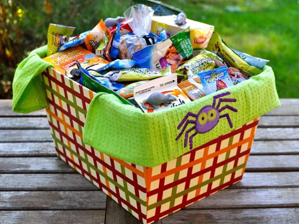 A Spoiling Bag or Basket filled with seasonal items for a college student, including snacks, drinks, vitamins and a bag of homemade Scrumptious Soft Peanut Brittle. 